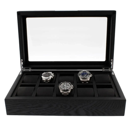 The Tempus Luxury Watch Winders 10 Watch Box Premium Black Oak Veneer features a glass lid, displays three silver watches in a row, and includes padded slots for up to ten timepieces.
