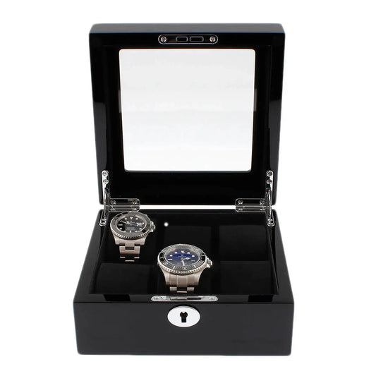 The Tempus Luxury Watch Winders 6 Watch Box in Premium Piano Black Gloss Finish with black luxury lining features a glass lid, metal hinges, and a keyhole front—shown open to display two luxury watches inside.
