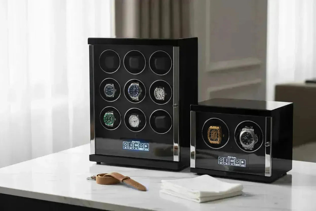 Two black, sleek watch winders with chrome accents, displaying multiple automatic watches.