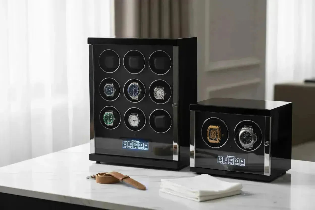 Two black watch winders, one large with 8 watches and one small with 2, on a white surface.