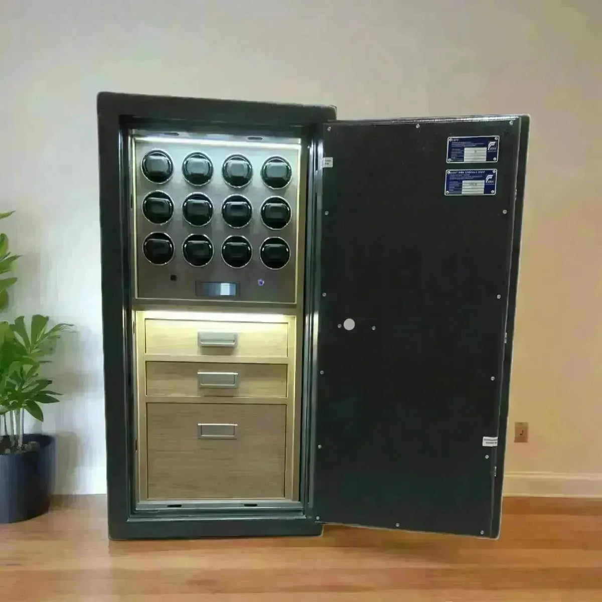 Luxury black safe featuring a twelve-watch winder display and wooden storage drawers with interior lighting.