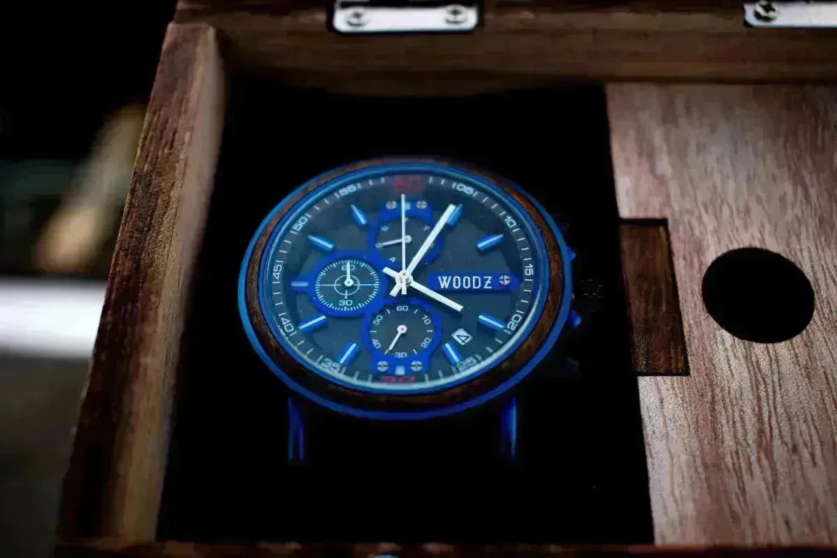 A stylish blue and black watch with a wooden bezel, nestled in a dark wood Tempus watch box.