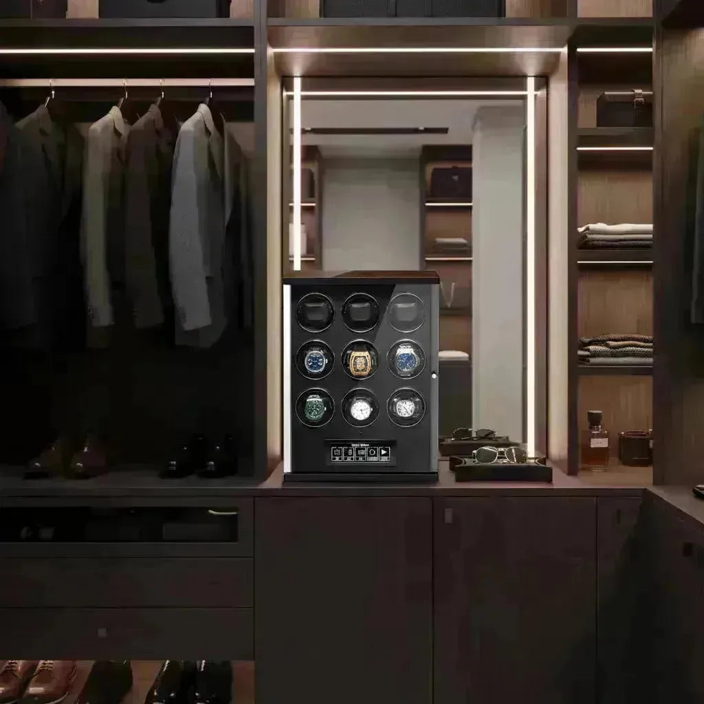 Modern black watch winder with nine rotating slots displayed in a luxury walk-in closet with warm LED lighting.