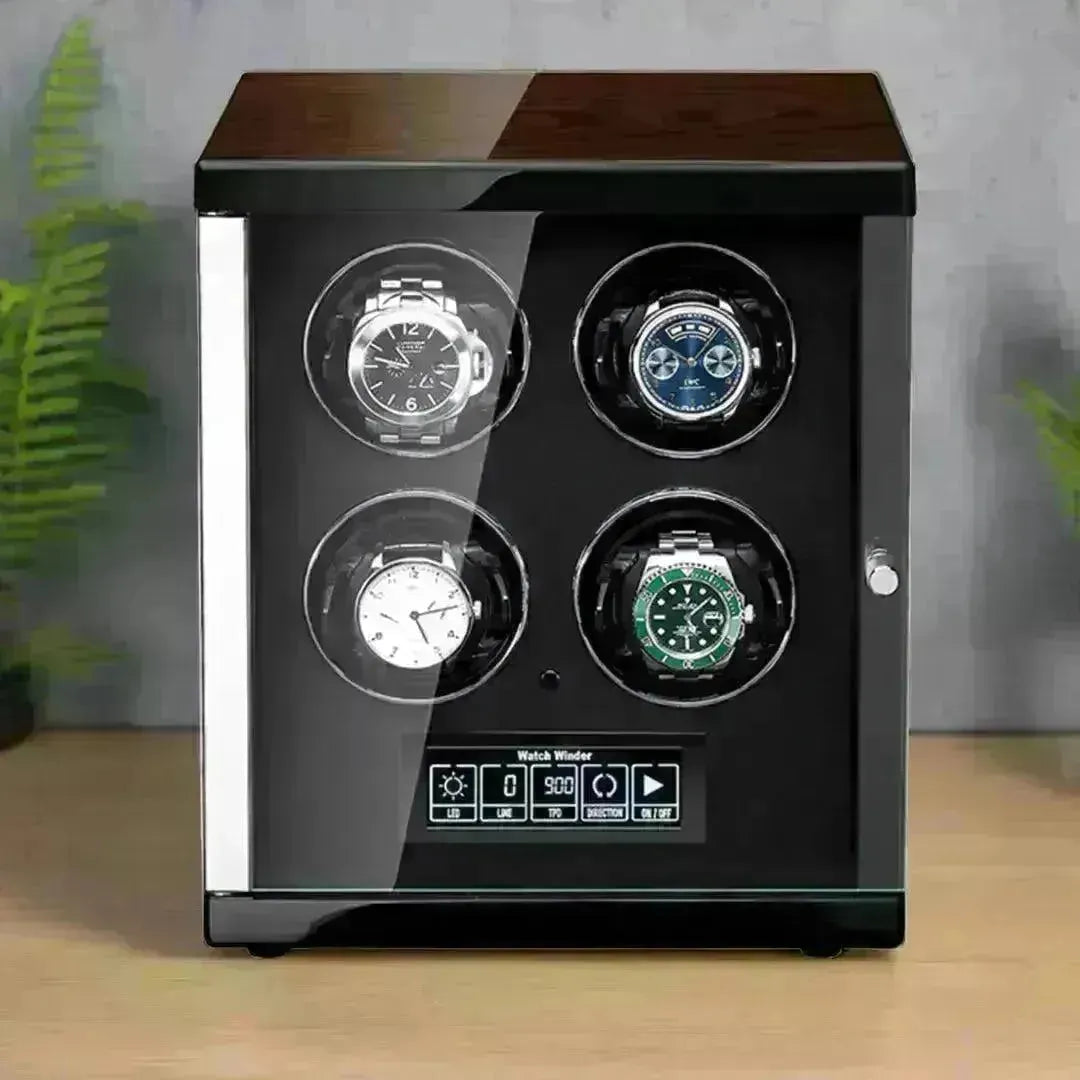 Luxury four-slot watch winder with a polished dark wood top, glass door, and digital control panel on a wooden surface.