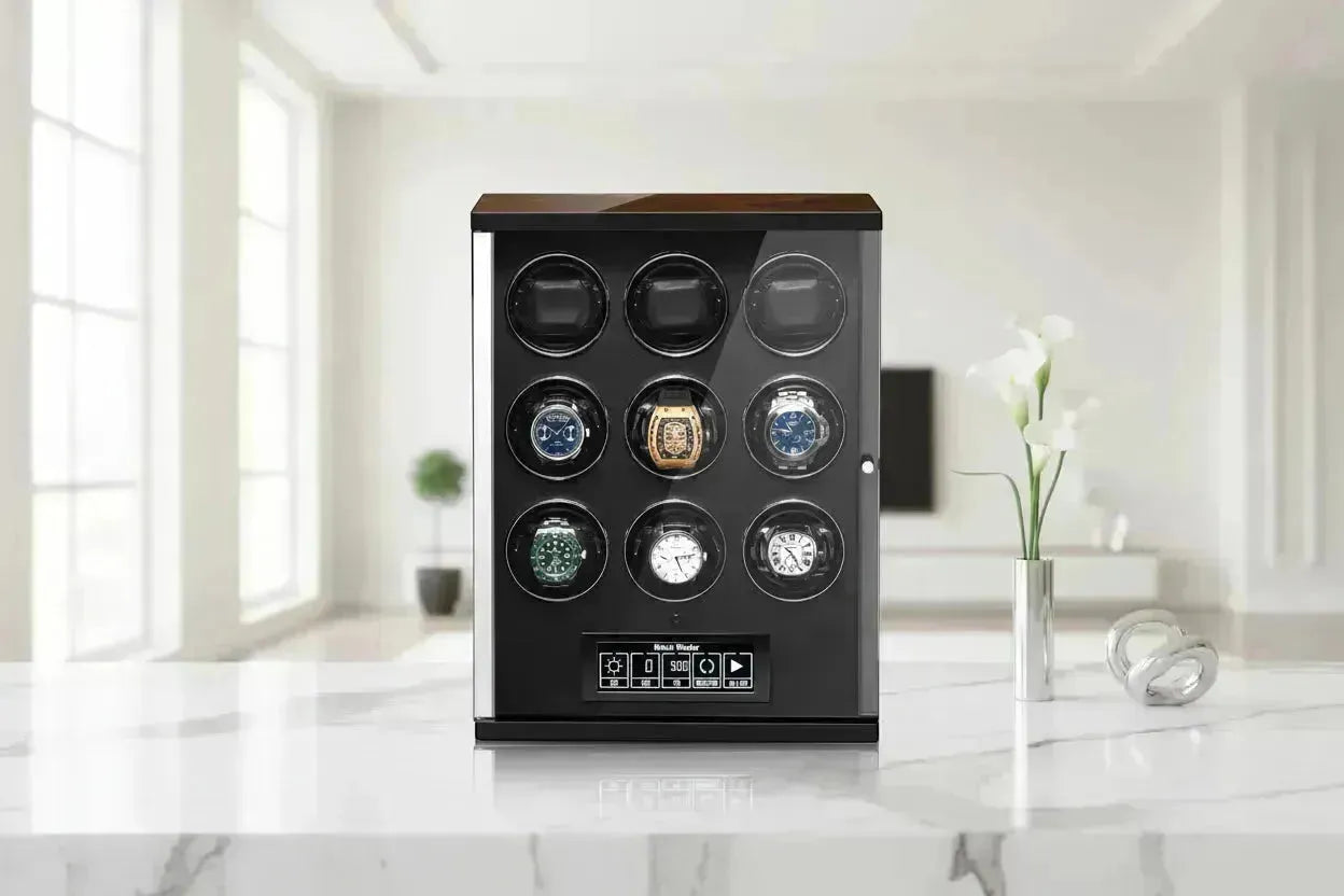 A sleek, black and wood watch winder with nine slots, holding six luxury watches, on a marble surface.