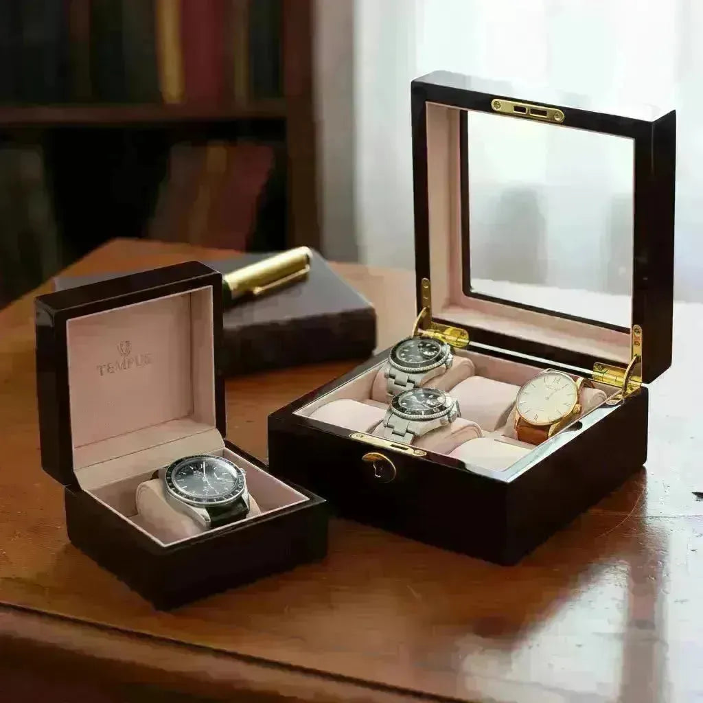 Dark wood Tempus watch boxes with glass lids and soft beige velvet interiors displaying luxury vintage timepieces.