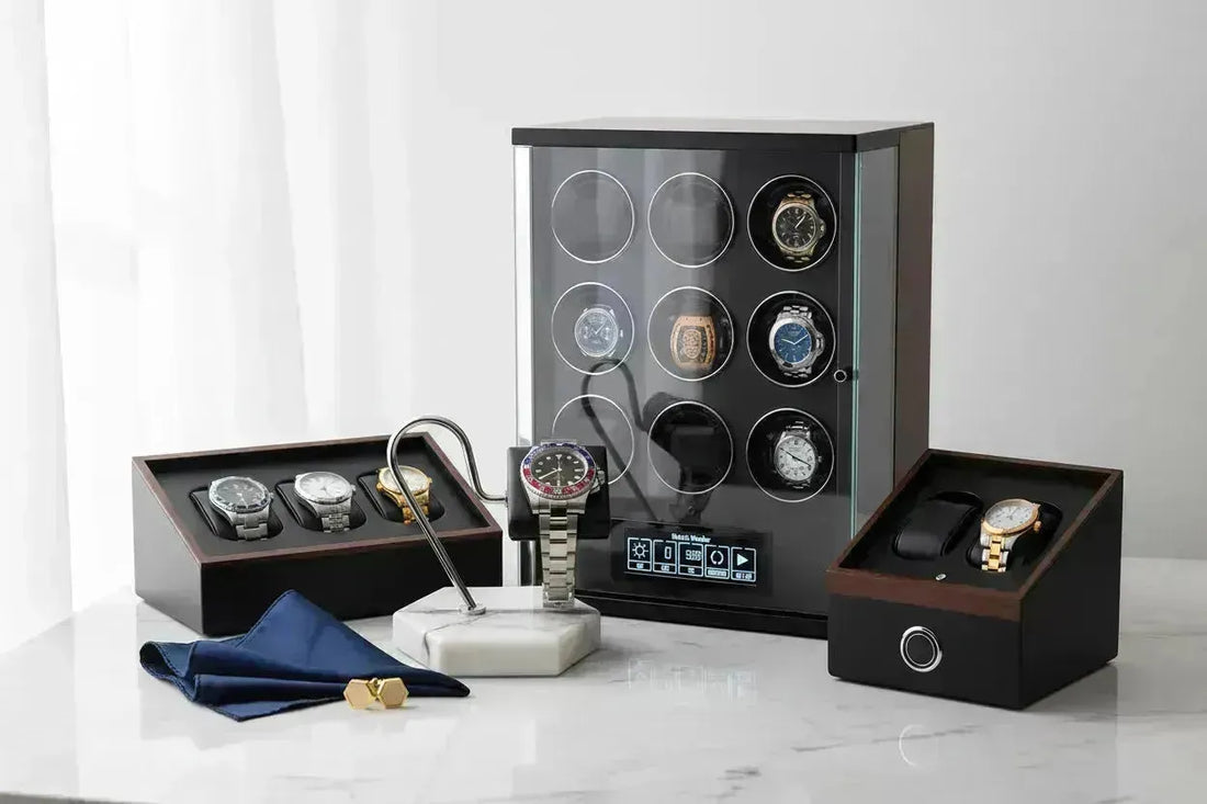 Luxury watch collection displayed with a marble stand, watch winders, and storage boxes.