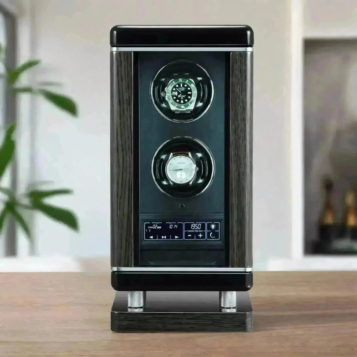 Modern dark wood luxury watch winder with digital display holding two premium timepieces on a wooden table.