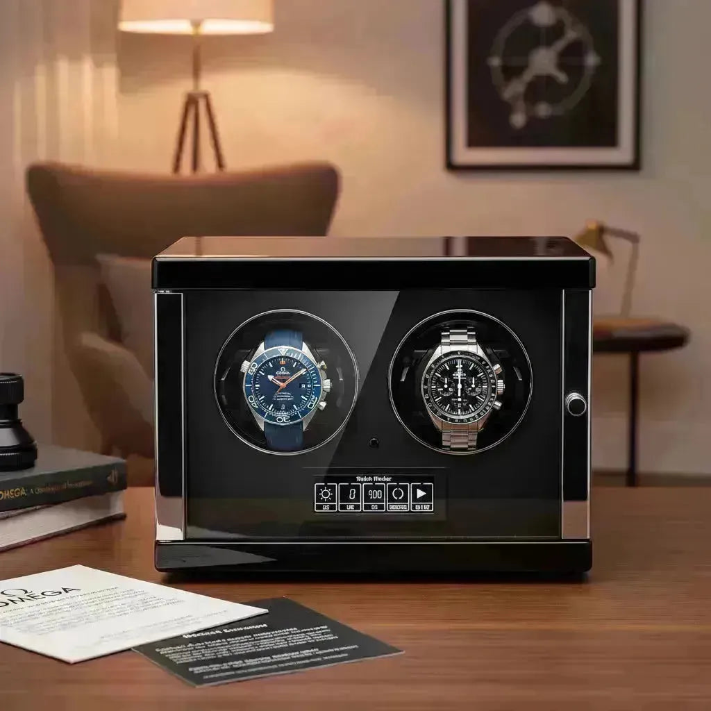 Dual black watch winder displaying an Omega Seamaster and Speedmaster, with controls visible.