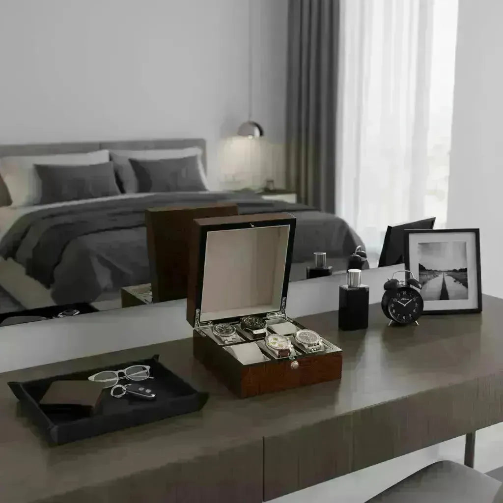 Elegant wooden watch box with multiple compartments displayed on a modern bedroom vanity.