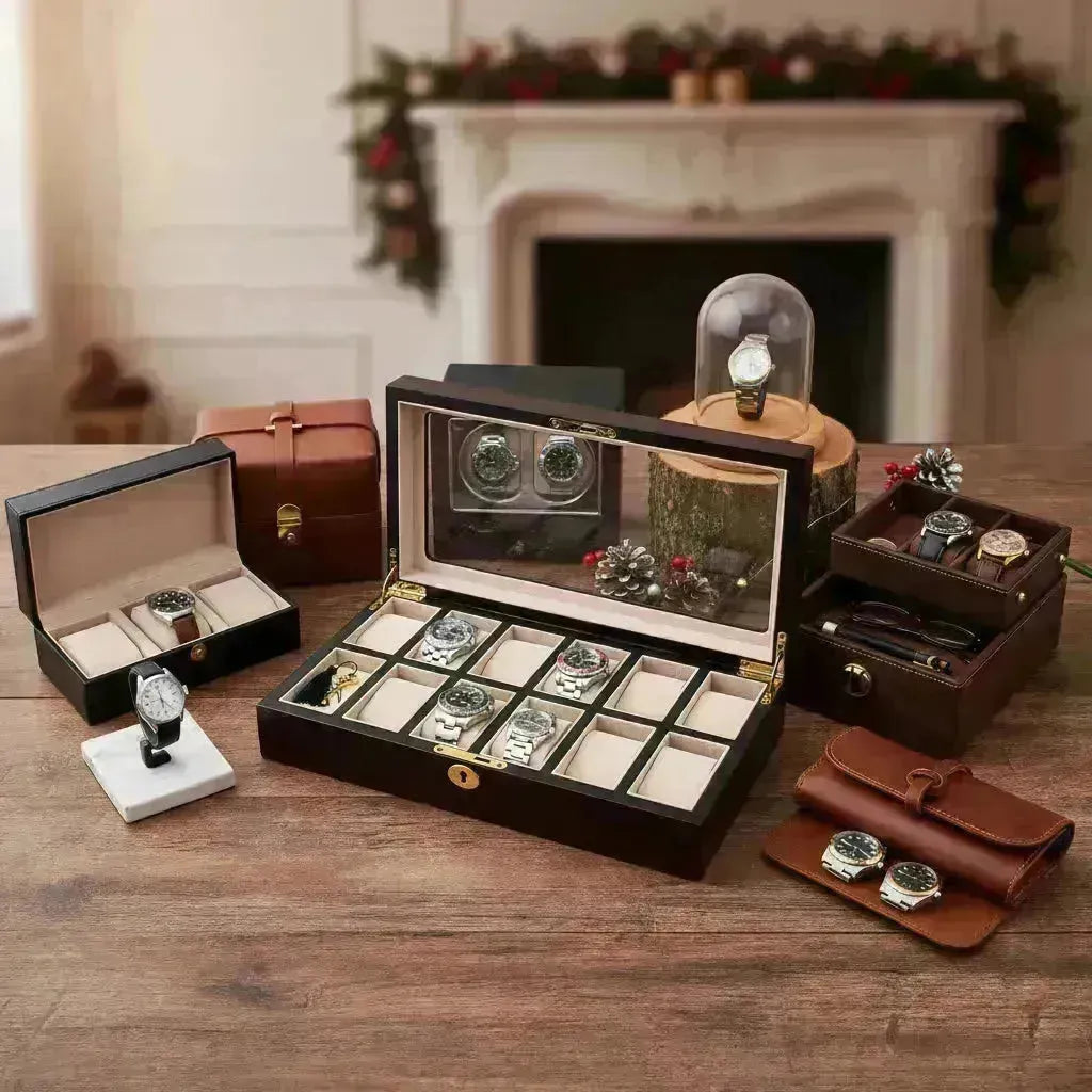 Elegant dark wood watch box with multiple compartments, leather watch rolls, and display cases on a wooden table.