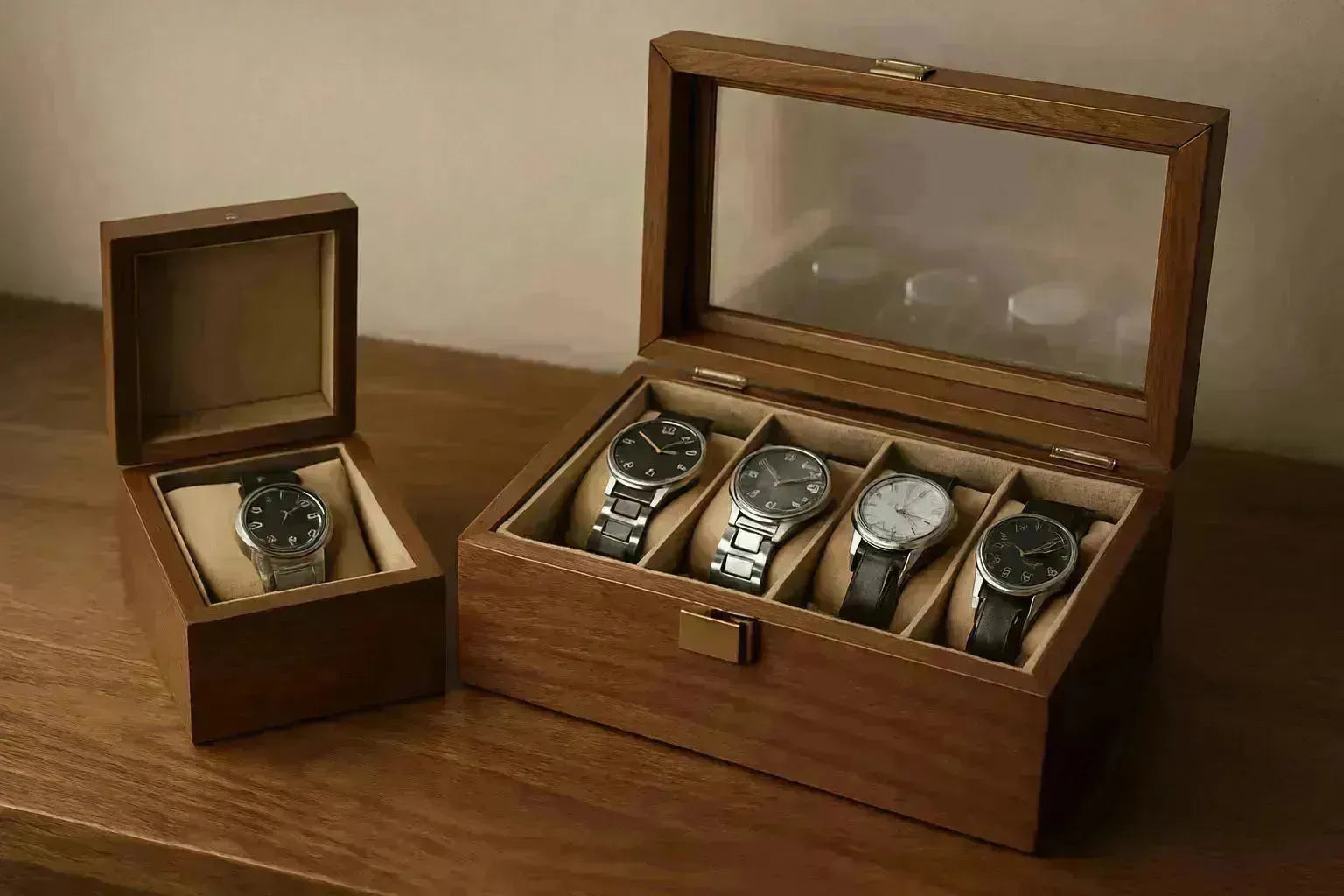 Two wooden watch boxes: a single watch box and a larger box holding four watches.
