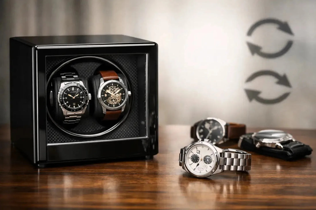 Black automatic watch winder holding two luxury timepieces with rotation icons on a wooden desk.