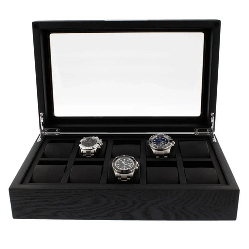 The Tempus Luxury Watch Winders 10 Watch Box Premium Black Oak Veneer features a glass lid, displays three silver watches in a row, and includes padded slots for up to ten timepieces.
