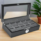 The Tempus Luxury Watch Winders 10 Watch Box in Black Piano Finish with a biometric lock and glass lid is open on a wooden table, with a green potted plant in the background.