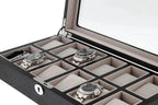 The Tempus Luxury Watch Winders 12 Watch Box features premium black oak veneer, a glass lid, and luxury storage for up to twelve wristwatches in cushioned compartments—some of which are shown empty.