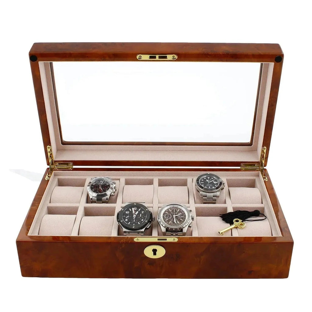 The Aevitas Watch Box for 12 Wrist Watches in Burl Walnut Wood has a glass lid, beige interior, and twelve compartments, offering premium storage for your collection. Most compartments are empty to showcase its spacious design.