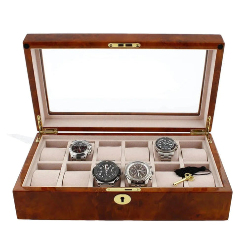 The Aevitas Watch Box for 12 Wrist Watches in Burl Walnut Wood has a glass lid, beige interior, and twelve compartments, offering premium storage for your collection. Most compartments are empty to showcase its spacious design.