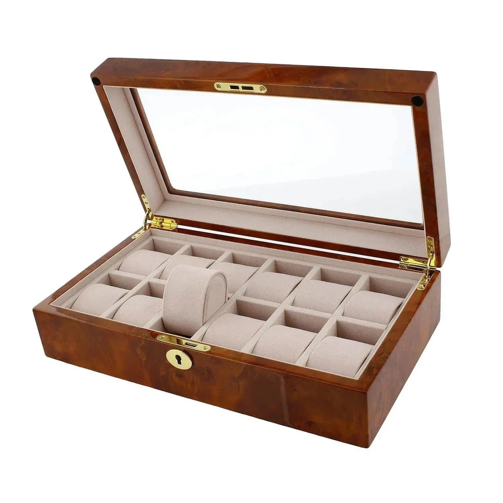 The Aevitas Watch Box for 12 Wrist Watches in Burl Walnut Wood features a glass lid, gold hinges, lock, and multiple beige cushioned compartments—perfect for organizing and displaying your watch collection in style.