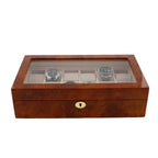 The Aevitas Watch Box for 12 Wrist Watches in Burl Walnut Wood features a polished brown finish, a glass lid, twelve compartments for storing luxury watches, and a gold lock on the front for added elegance.