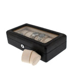 The Tempus Luxury Watch Winders 12 Watch Box in Carbon Fibre Printed Leather features a glass lid, premium black finish, and displays multiple watches. One beige cushion sits outside, showcasing the luxury storage for individual timepieces.