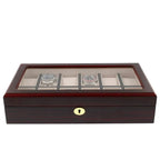 The Tempus Luxury Watch Winders 12 Watch Box features a premium cherry wood satin finish, a glass top displaying two watches, multiple light fabric-lined compartments for storage, and a secure lock.