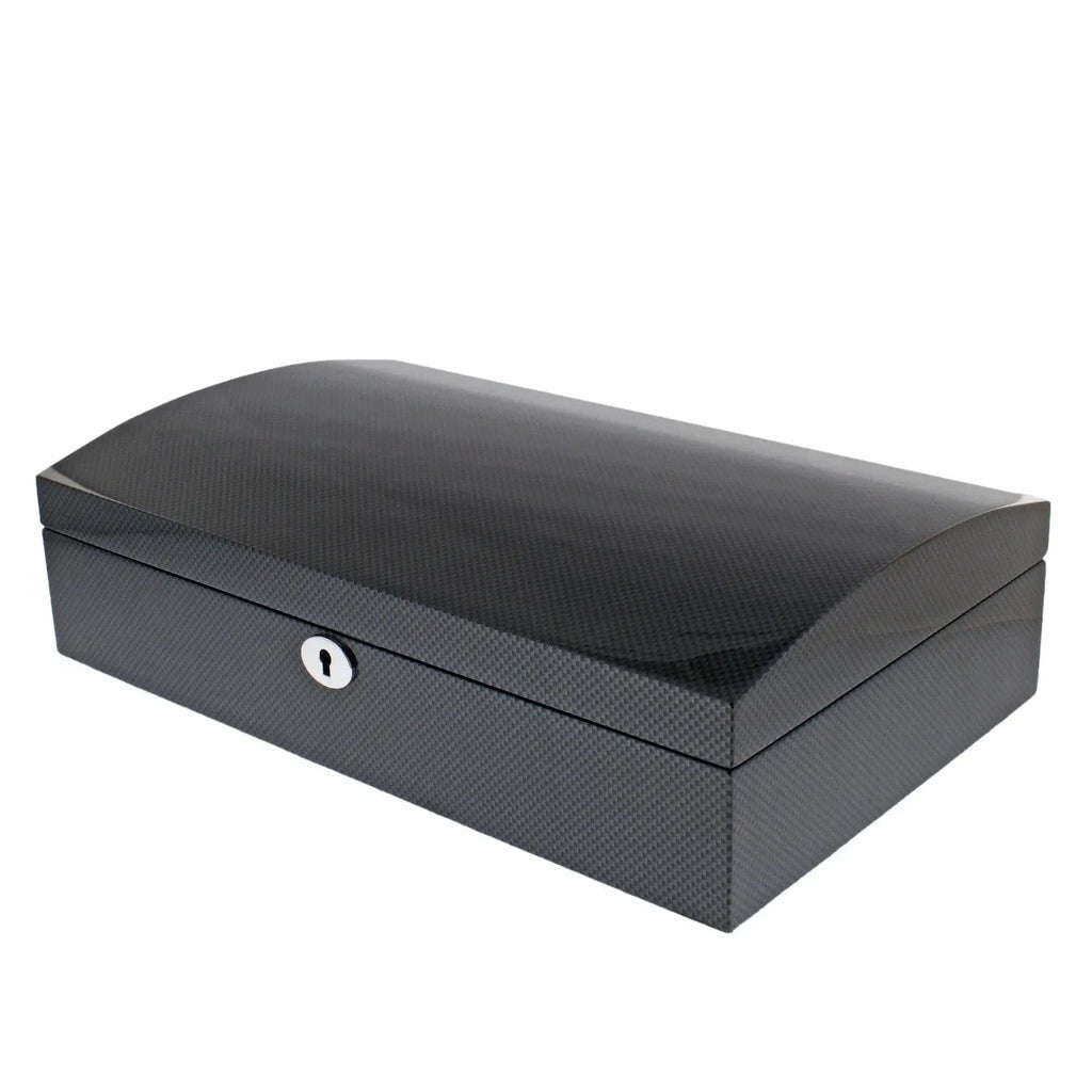 The Aevitas 12 Watch Box features a sleek rectangular carbon fibre finish, curved solid lid, subtle textured pattern, and a front keyhole for secure storage.