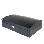 The Aevitas 12 Watch Box features a sleek rectangular carbon fibre finish, curved solid lid, subtle textured pattern, and a front keyhole for secure storage.