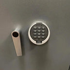 A close-up of the Tempus Luxury Watch Winders 12 Watch Winder Safe Grade 3, featuring a keypad lock with numbers and symbols and a silver handle, offering a £350,000 insurance rating.