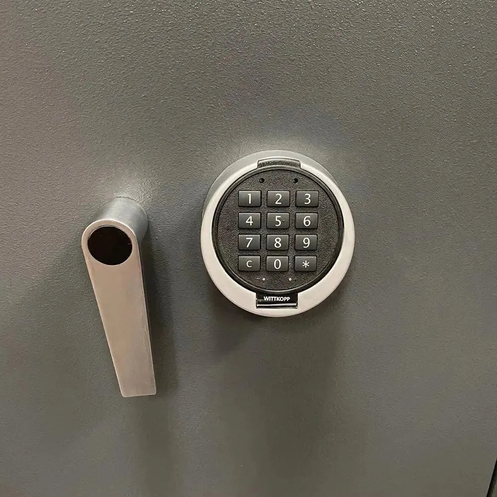 A close-up of the Tempus Luxury Watch Winders 12 Watch Winder Safe Grade 3, featuring a keypad lock with numbers and symbols and a silver handle, offering a £350,000 insurance rating.