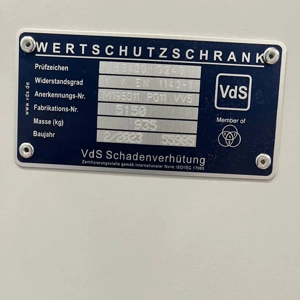 A close-up of the metal ID plate on the Tempus 12 Watch Winder Safe Grade 4, showing technical details in German like model number, manufacturer (Tempus Luxury Watch Winders), insurance rating (£600,000), and the VdS certification logo.