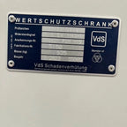 A close-up of the metal ID plate on the Tempus 12 Watch Winder Safe Grade 4, showing technical details in German like model number, manufacturer (Tempus Luxury Watch Winders), insurance rating (£600,000), and the VdS certification logo.