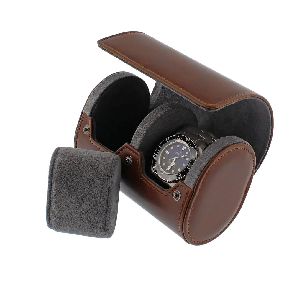 Vintage brown vegan leather 2-watch roll with soft grey suede lining, holding a silver watch.