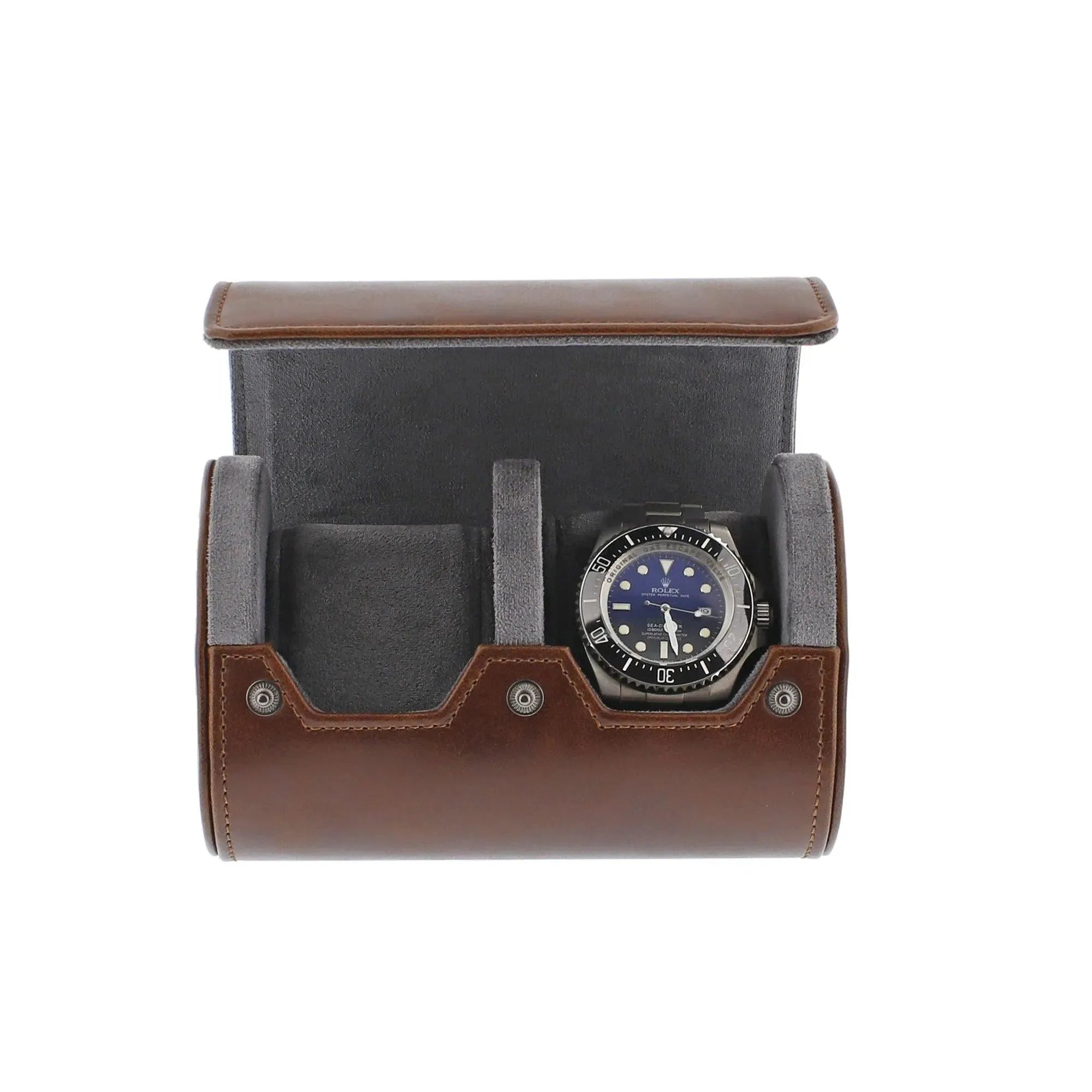 Vintage brown leather 2-watch roll with soft grey suede lining, holding a blue-faced watch.