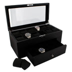 The 22 Watch Box Premium Quality Black Oak Veneer with Drawer by Tempus Luxury displays three watches under a glass lid, has multiple compartments, an open drawer holding one watch, and two watch cushions beside it.