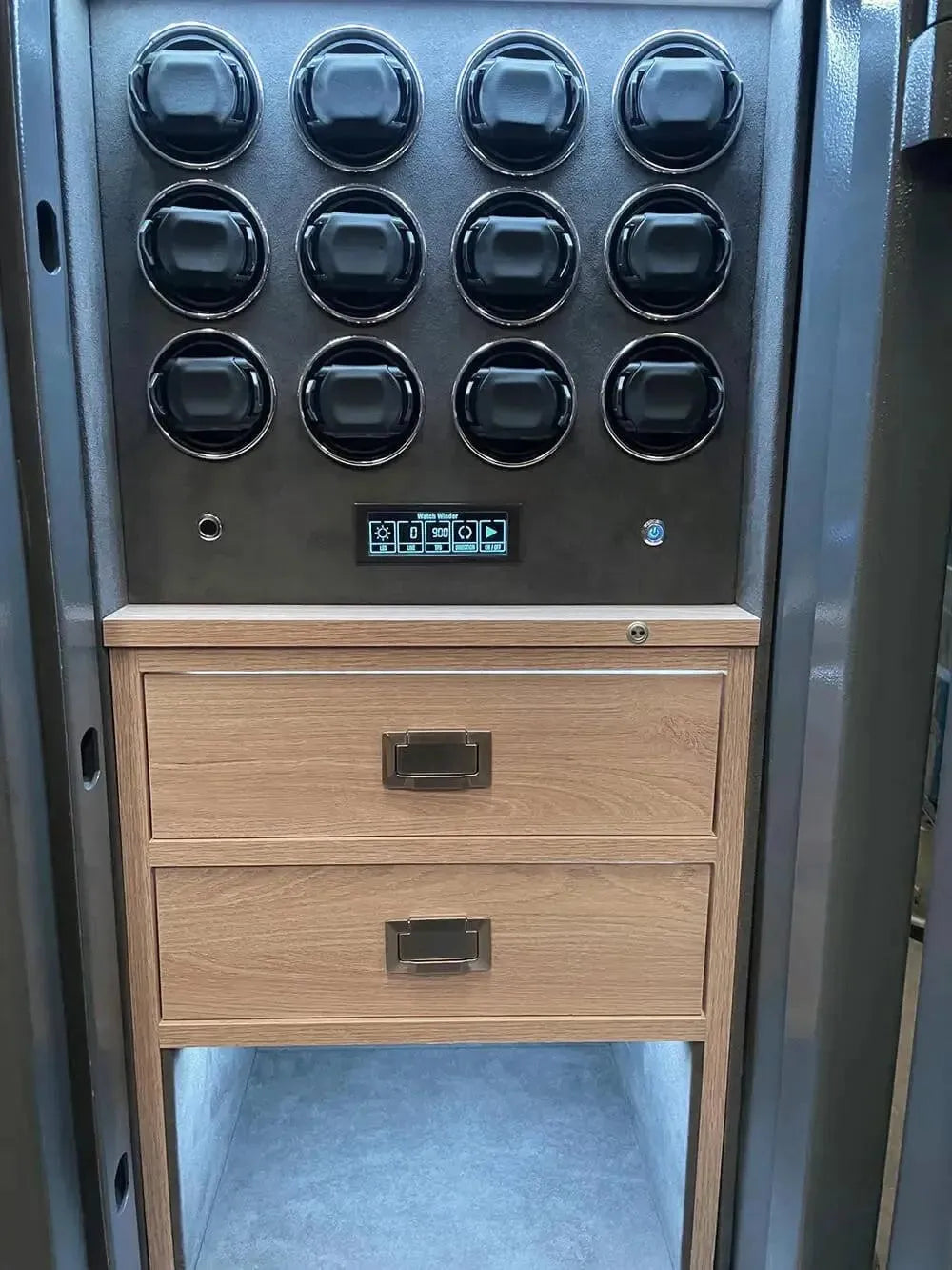 The Tempus Luxury Watch Winders 24 Watch Winder Safe Grade 3 features two wooden drawers, a digital control panel, and twelve round black containers above—ideal for securely winding and storing watches with £350,000 insurance coverage.