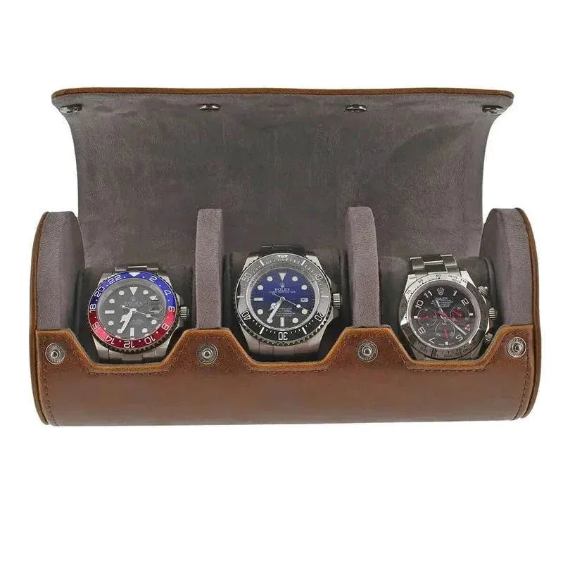 Triple Watch Roll features vintage brown leather and a super soft grey suede lining, holding three silver wristwatches with red/blue, blue, and black faces for a stylish display.