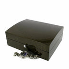 A Tempus Luxury Watch Winders 8 Watch Box in premium green high-gloss lacquered crocodile print finish sits closed, with a silver wristwatch featuring a dark face placed in front of it on a white background.