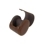 The Single Watch Roll in vintage brown leather features a hinged lid and super soft grey suede lining—an elegant travel case designed to protect your timepiece.