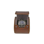 A wristwatch with a black dial and bezel is displayed in the Premium Single Watch Roll, featuring vintage brown leather and super soft grey suede lining, set open with metal snap buttons against a plain white background.