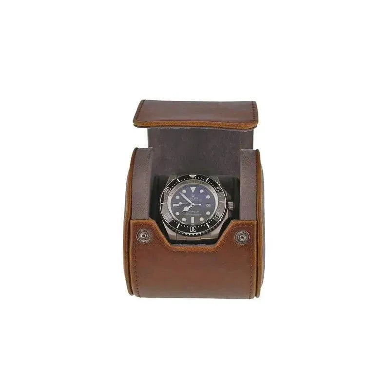 A wristwatch with a black dial and bezel is displayed in the Premium Single Watch Roll, featuring vintage brown leather and super soft grey suede lining, set open with metal snap buttons against a plain white background.