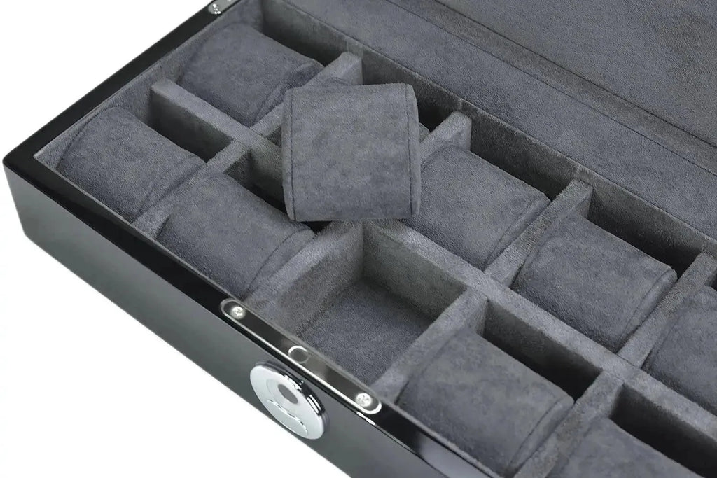 A close-up of the Tempus 10 Watch Box in Black Piano Finish by Tempus Luxury Watch Winders, showcasing its soft gray interior with 10 compartments and removable padded cushions. One cushion rests atop the compartments. Features a Bio Metric Lock.