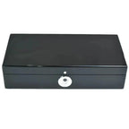 The Tempus Luxury Watch Winders Tempus 10 Watch Box in black piano finish features a shiny silver circular biometric lock on the front, shown against a white background.