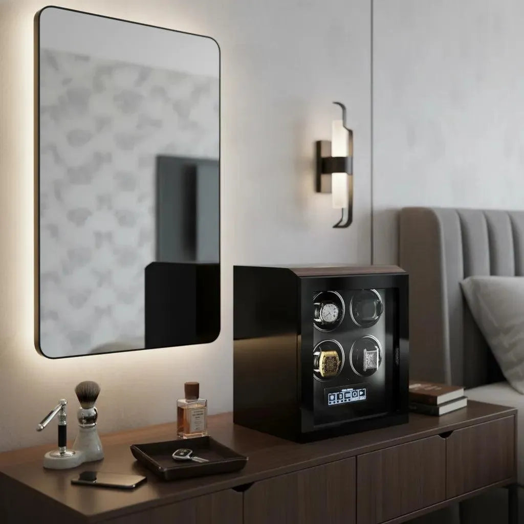 A modern bedroom showcases a Tempus Luxury Watch Winders Tempus 4 Watch Winder for Automatic Watches with Touch Screen atop a wooden dresser, alongside grooming tools, cologne, and mirror. The bed and a wall sconce appear in the background.