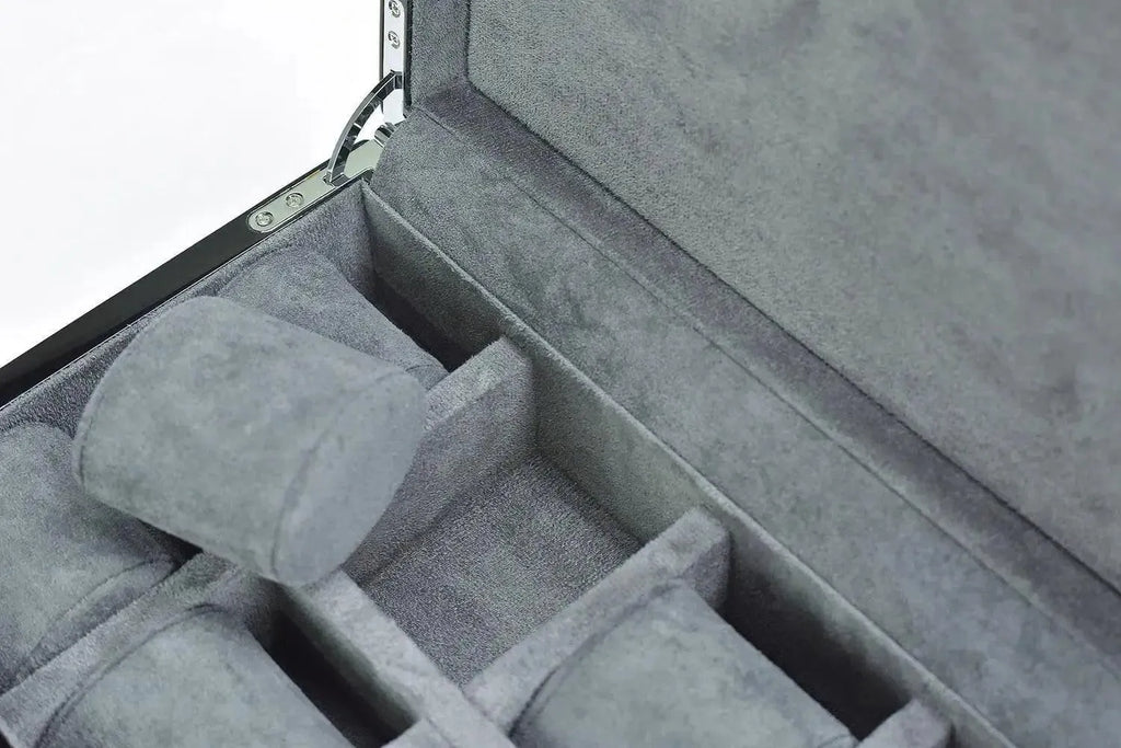 A close-up of the Tempus 8 Watch Box in Black Piano Finish by Tempus Luxury Watch Winders, featuring a gray velvet-lined interior with several cushioned watch compartments and an open display of organized storage spaces.