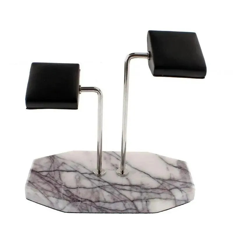 The Tempus Double White Marble Watch Stand by Tempus Luxury Watch Winders features dark violet veins and two metal rods with black leather pads—ideal for stylishly displaying your watches or bracelets.