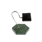 The Tempus Watch Stand by Tempus Luxury Watch Winders features a green marble hexagon base with black leather, complemented by a modern curved silver arm and rectangular black lamp head, echoing the style of a contemporary desk lamp.