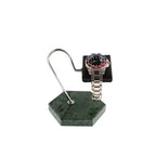 A silver wristwatch with a red and blue bezel is showcased on the Tempus Watch Stand by Tempus Luxury Watch Winders, featuring a green marble hexagonal base with black leather, against a white background.