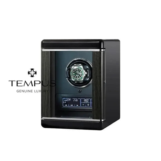 Black watch winder with glass window and watch inside.
