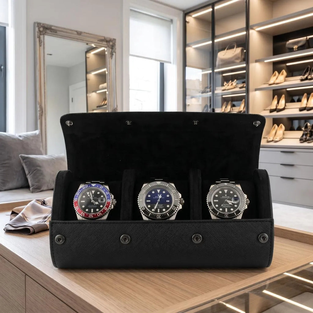 Close-up of black saffiano leather watch roll with textured exterior, fine stitching, dark metal closures in a bright luxury dressing room.